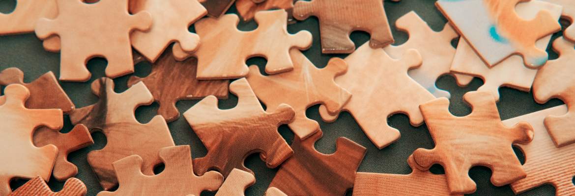beige jigsaw pieces on a table