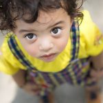 boy looking up at camera blankly